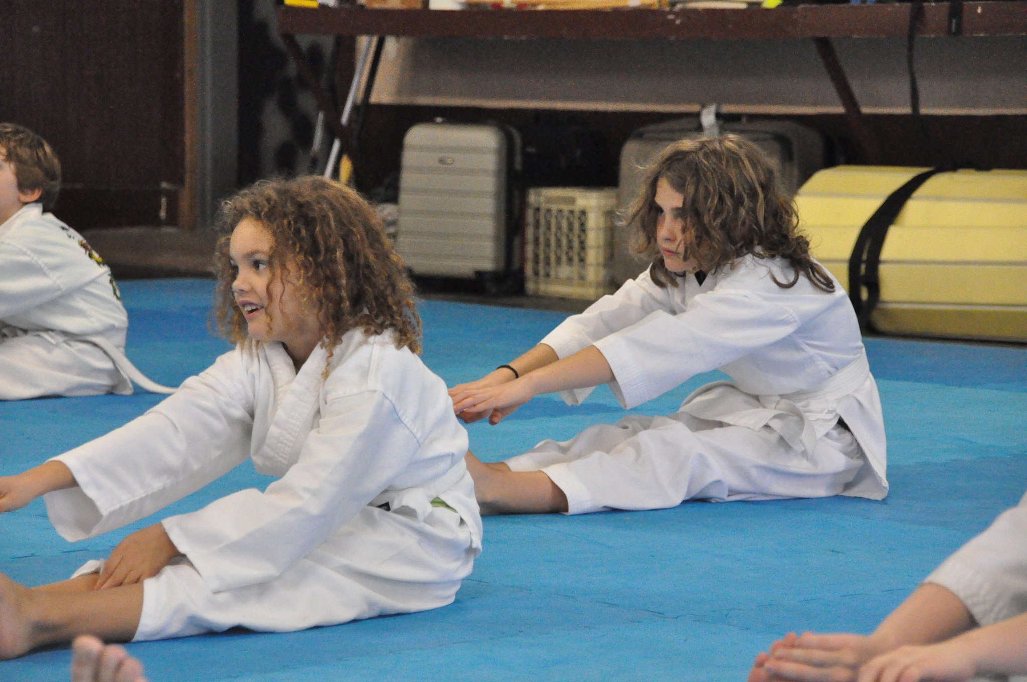 Kids stretching in kung fu class.