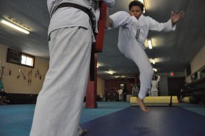 Jump kick in kids kung fu class