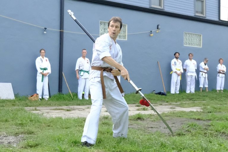John practices the kwandao or Chinese halberd.